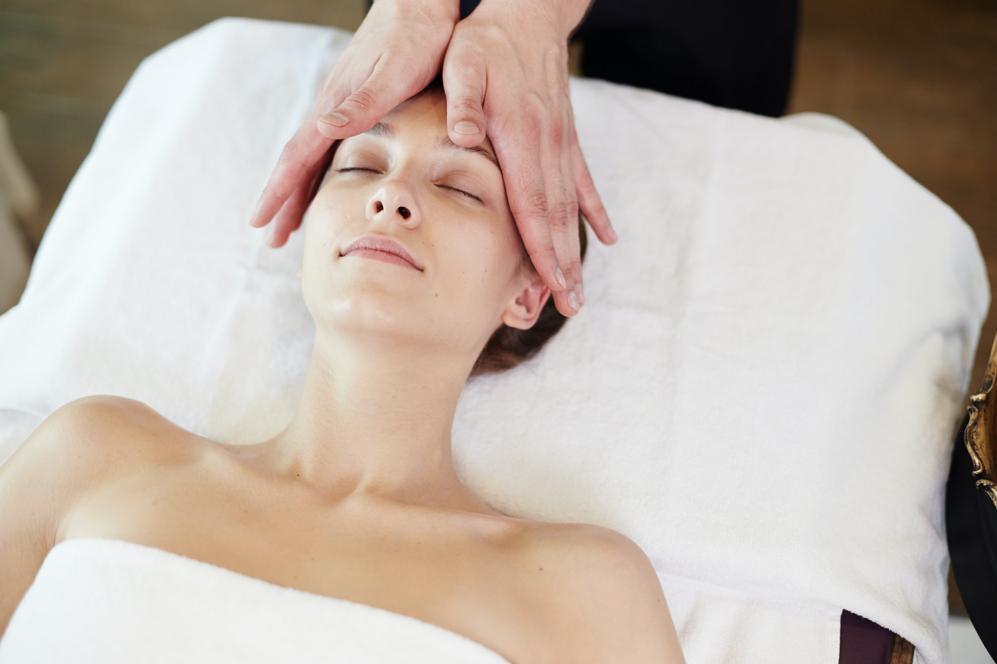 Woman Enjoying Face Lifting Massage in SPA